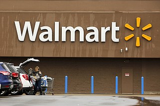 FILE - A shopper loads her car after shopping at a Walmart in Pittsburgh, Thursday, Feb. 22, 2018. (AP/Gene J. Puskar, File)
